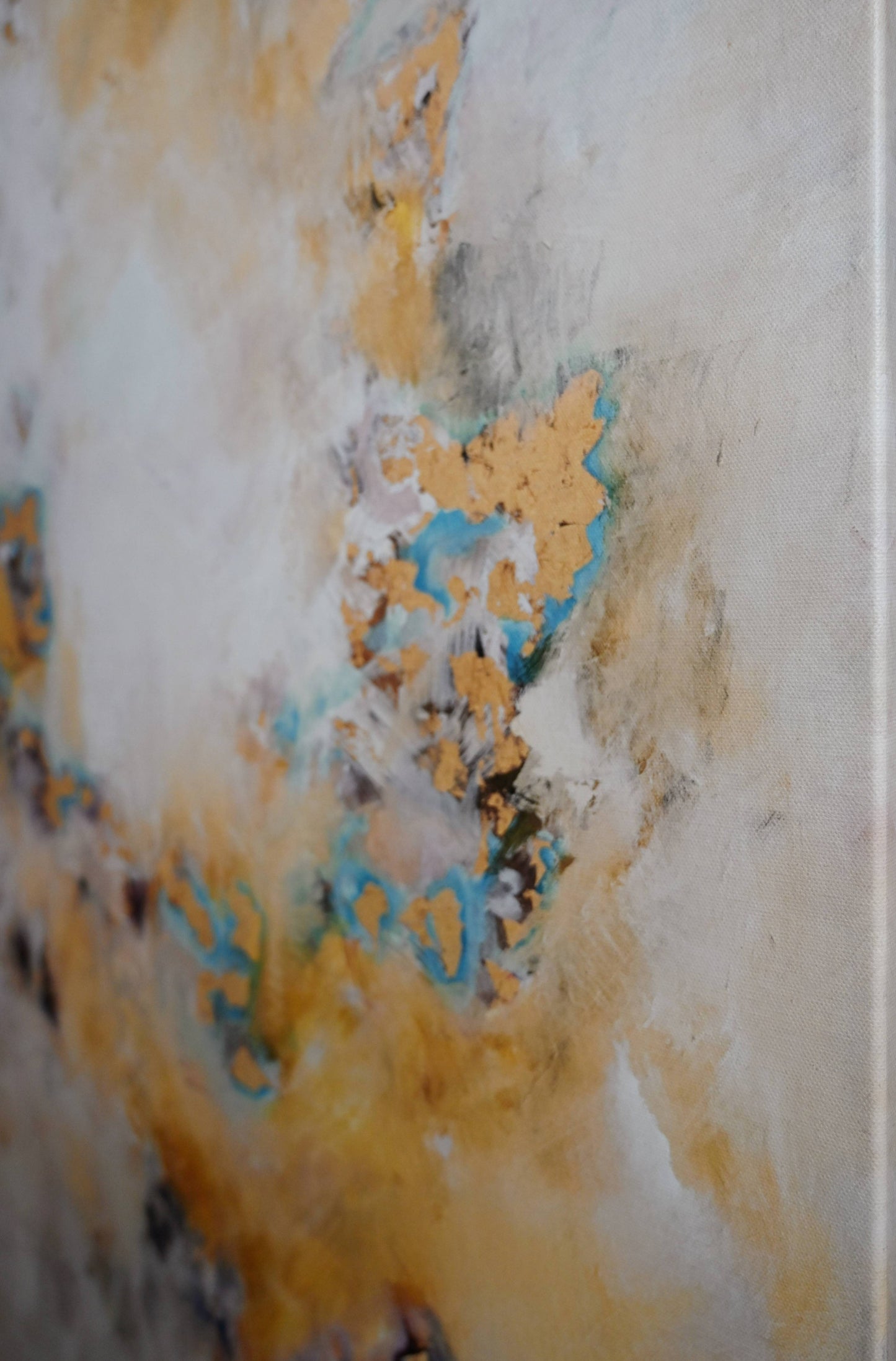 Gold abstract art with pops of teal
