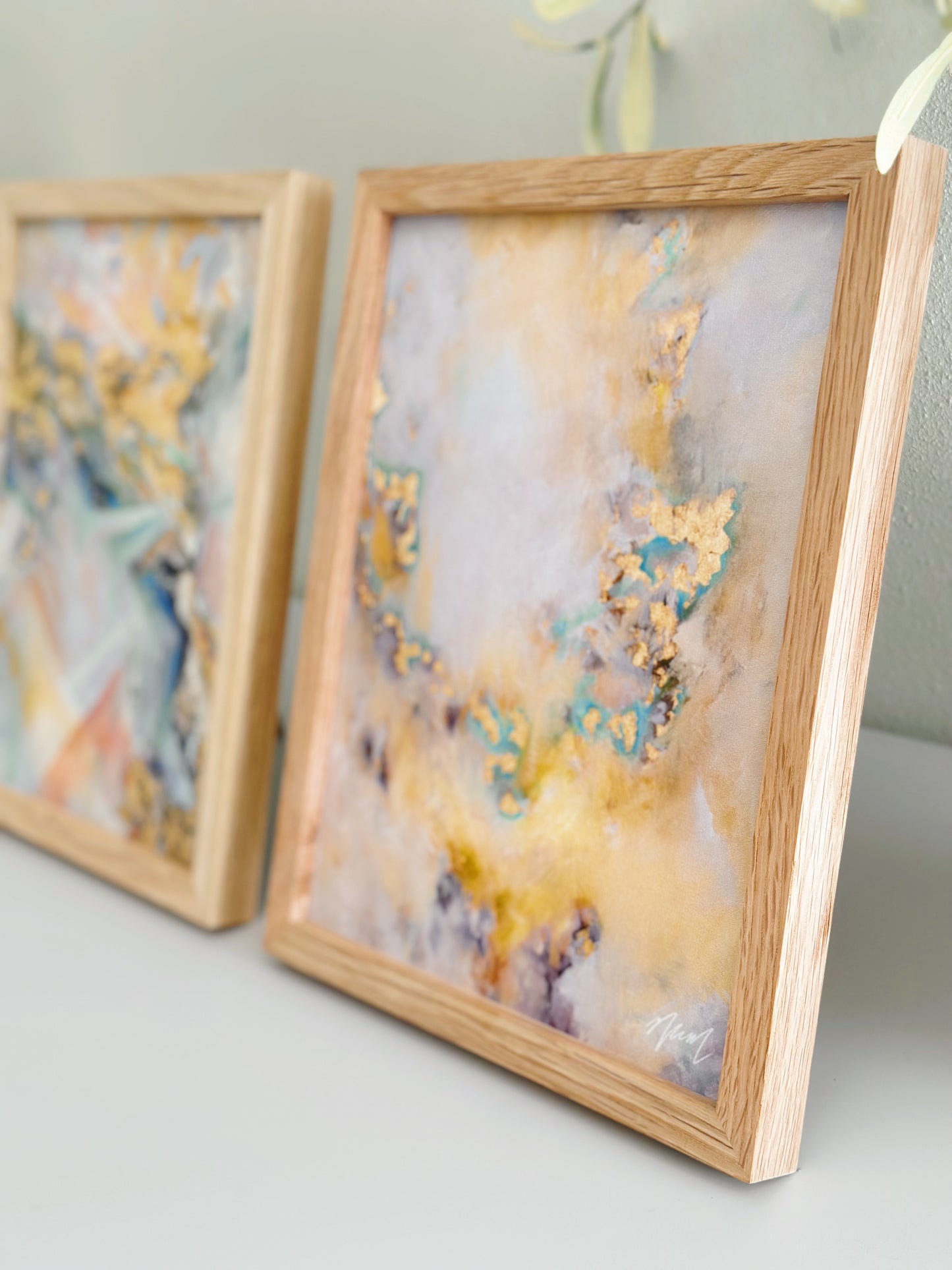 Gold abstract art with pops of teal